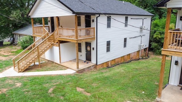 rear view of house featuring a lawn