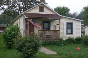 view of front of property with a porch and a front yard