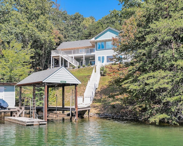 view of dock featuring a water view, stairway, and boat lift