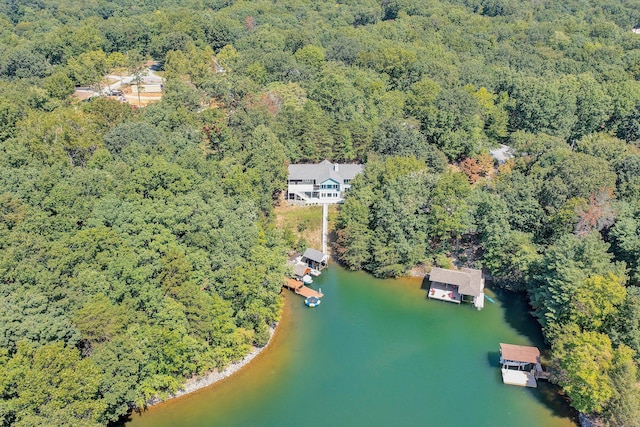 drone / aerial view featuring a water view and a wooded view