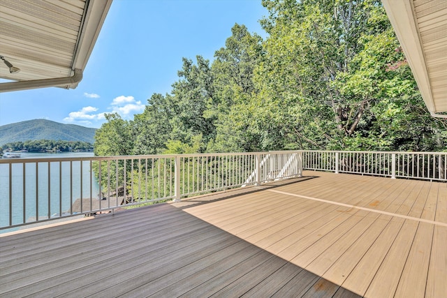 wooden deck with a water and mountain view