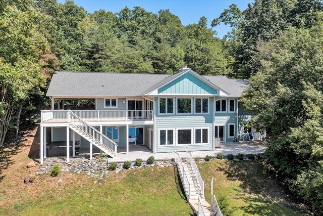 rear view of house with a yard and a patio