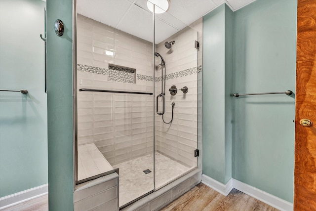 bathroom with walk in shower and hardwood / wood-style flooring