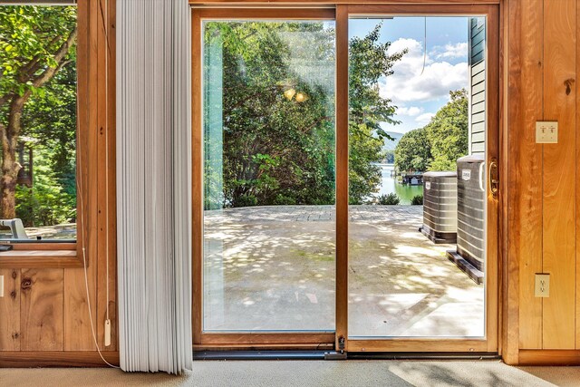 entryway with a water view and carpet flooring