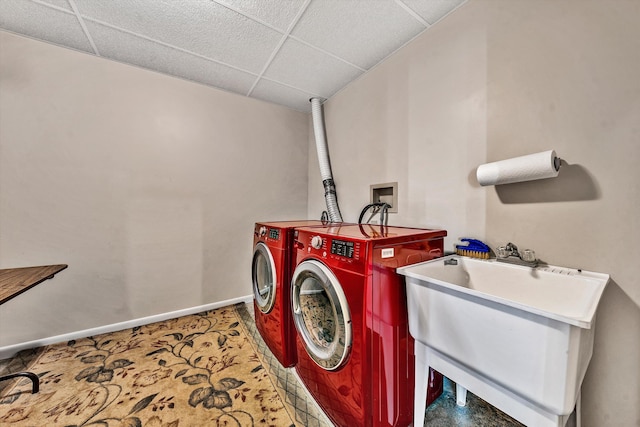 washroom featuring washing machine and clothes dryer, sink, and carpet