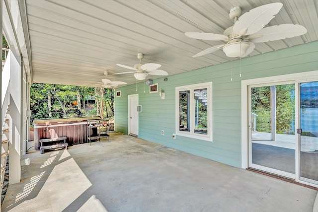 view of patio featuring ceiling fan and a hot tub