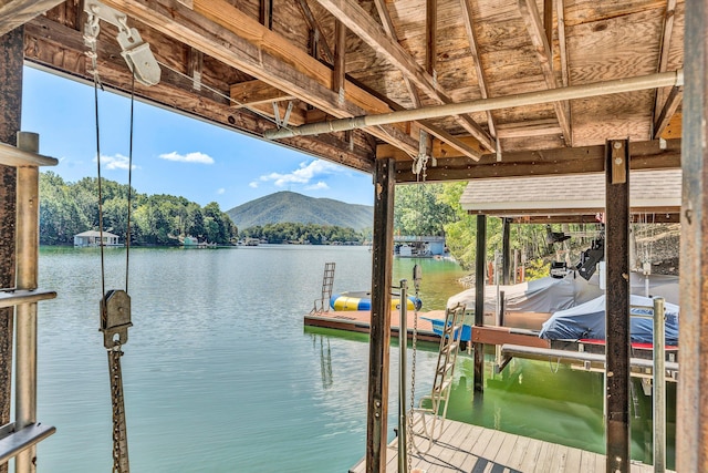 view of dock featuring a water and mountain view