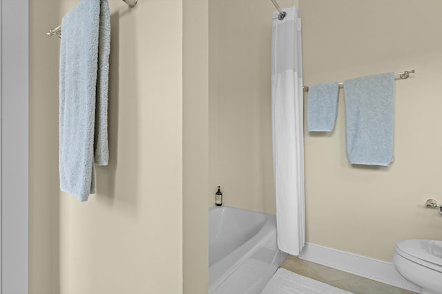 bathroom featuring toilet, shower / tub combo with curtain, and tile patterned floors