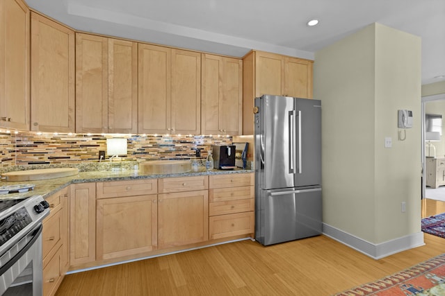 kitchen with light brown cabinetry, backsplash, light wood-type flooring, light stone countertops, and stainless steel appliances