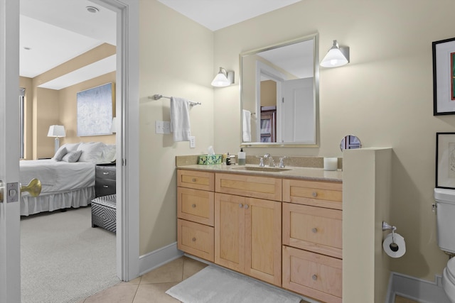 bathroom featuring tile patterned flooring, vanity, and toilet