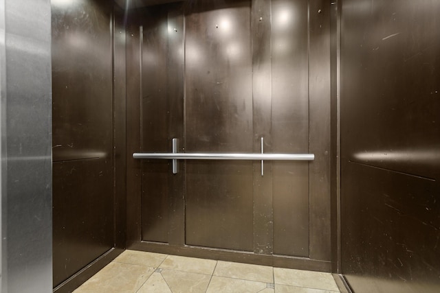 interior details with elevator and tile patterned floors