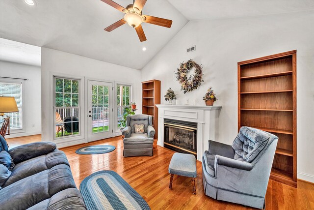 living room featuring ceiling fan, light hardwood / wood-style flooring, and high vaulted ceiling