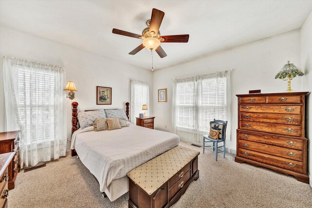 bedroom featuring ceiling fan and light colored carpet