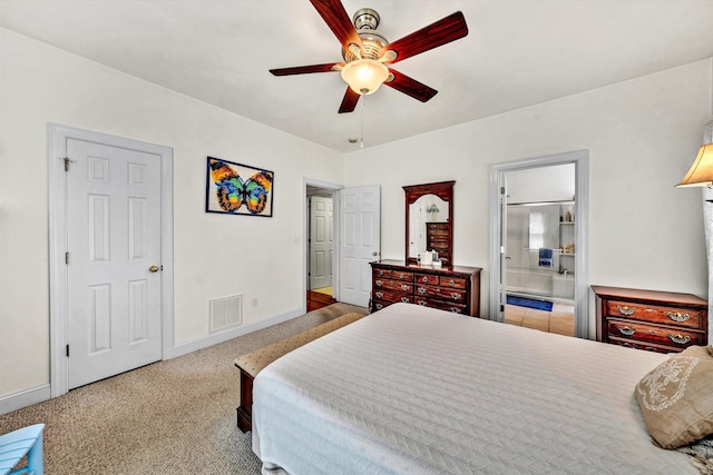 bedroom featuring carpet flooring, ensuite bath, and ceiling fan