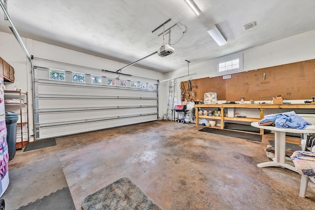 garage featuring a garage door opener and a workshop area