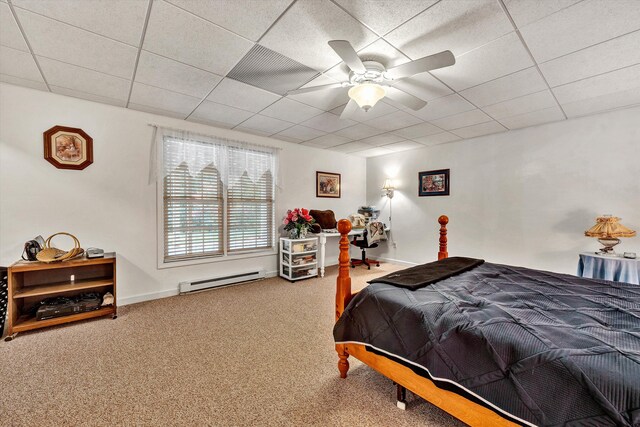 bedroom featuring carpet flooring, a baseboard heating unit, ceiling fan, and a drop ceiling