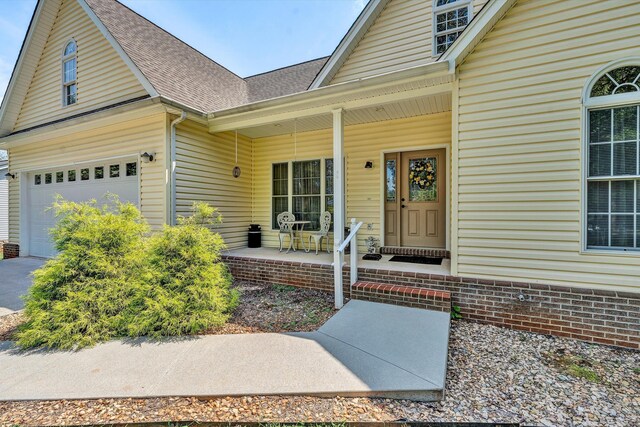 property entrance with a garage and covered porch