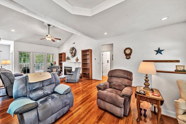 living room with vaulted ceiling with beams, hardwood / wood-style floors, and ceiling fan