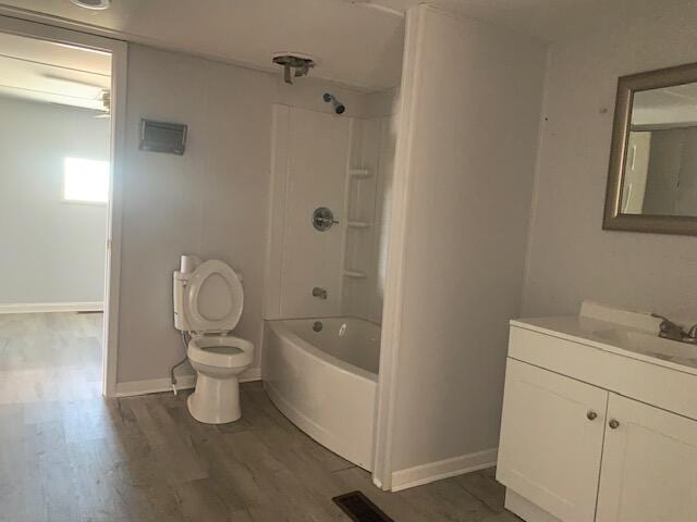 full bathroom with toilet,  shower combination, vanity, and hardwood / wood-style floors