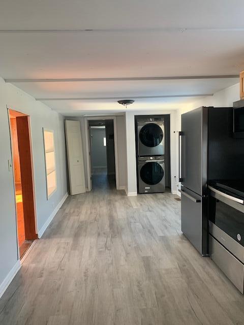 interior space featuring light hardwood / wood-style floors and stacked washer / dryer