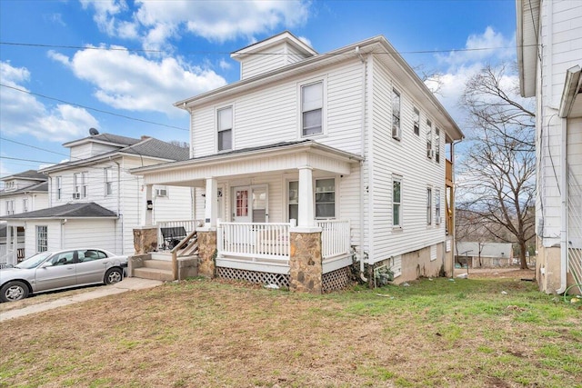 view of front of property with a porch and a front lawn