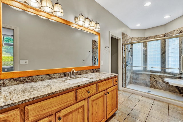 bathroom featuring a shower with shower door, tile patterned flooring, and vanity