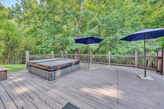 deck featuring a covered hot tub