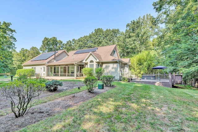 view of front facade with a wooden deck and a front lawn