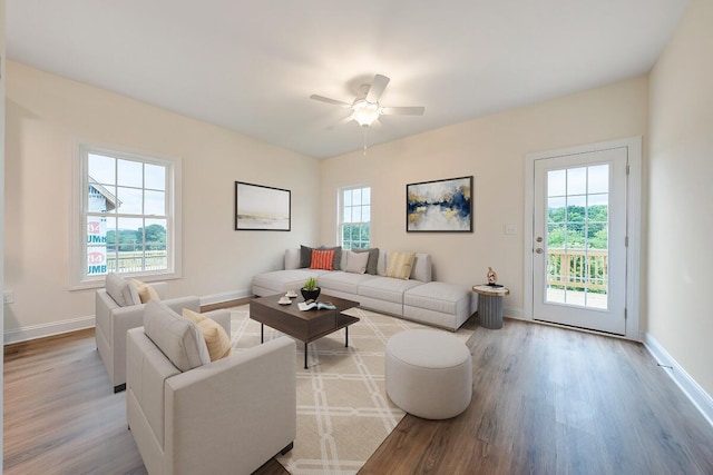 living area featuring ceiling fan, wood finished floors, and baseboards