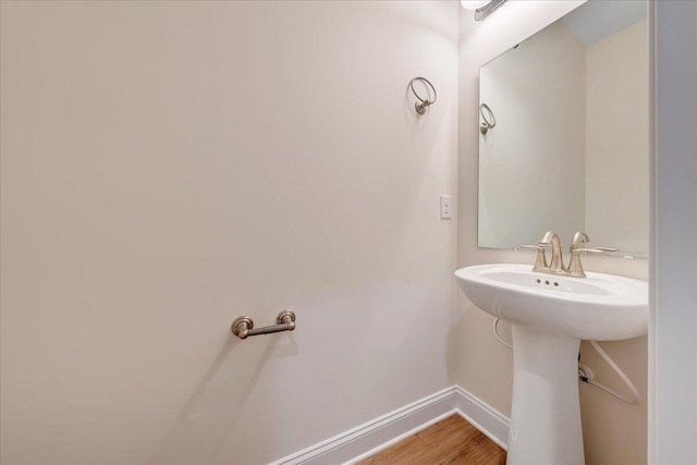 bathroom with wood finished floors and baseboards