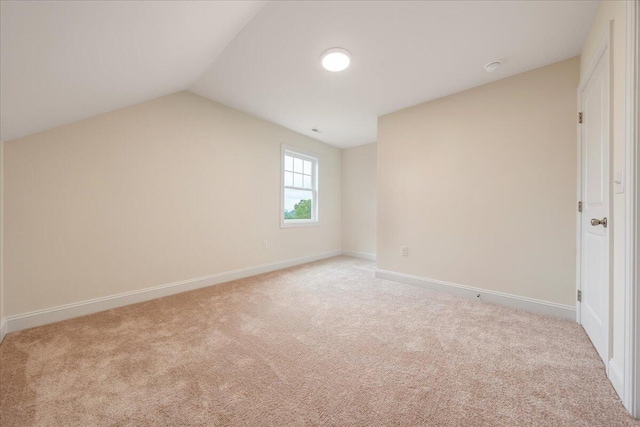 additional living space with lofted ceiling, carpet, and baseboards