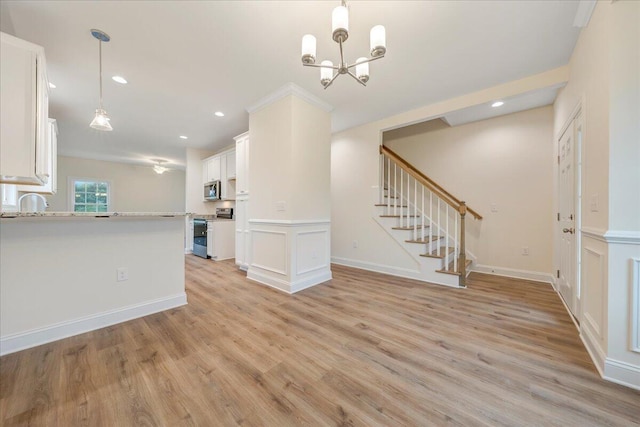 unfurnished living room with recessed lighting, light wood-style flooring, baseboards, and stairs