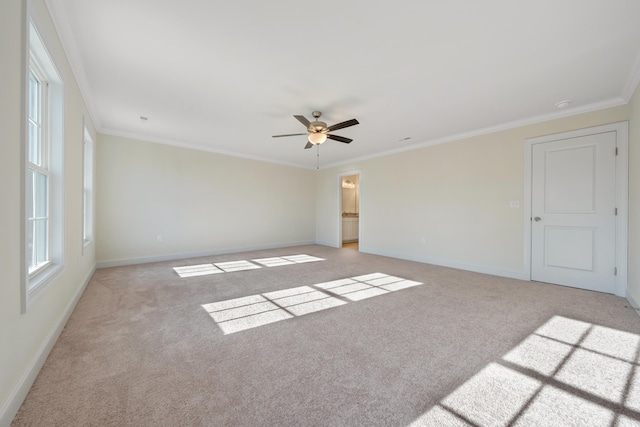 empty room featuring ornamental molding, ceiling fan, and light colored carpet