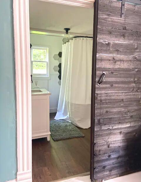 bathroom with vanity, wood-type flooring, and walk in shower