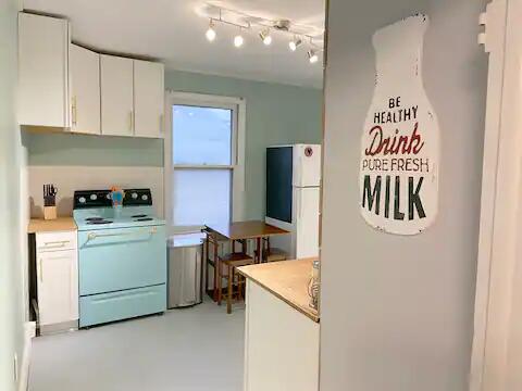 kitchen featuring white appliances and white cabinets