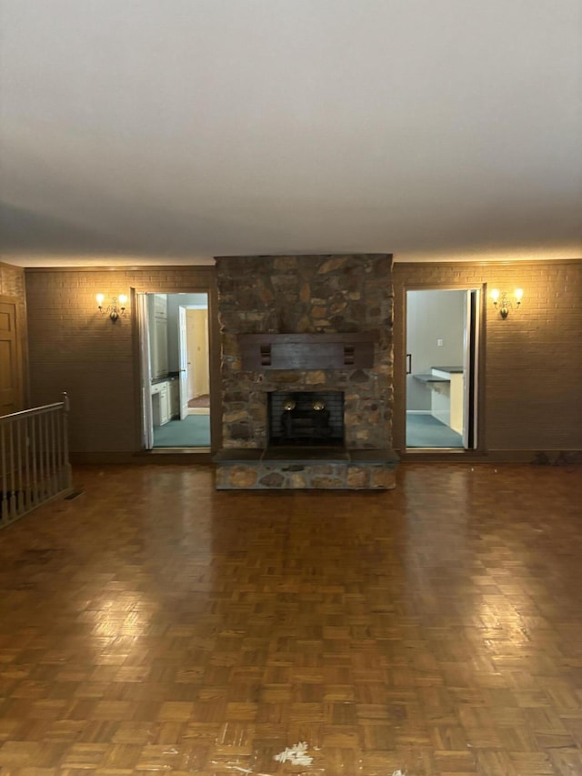 unfurnished living room with wooden walls and a fireplace