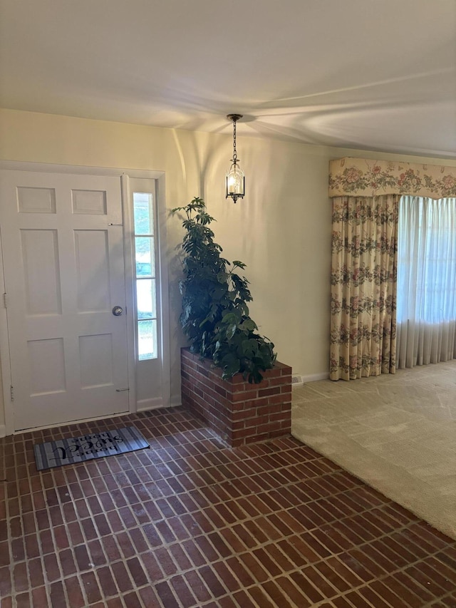 carpeted entryway featuring a wealth of natural light