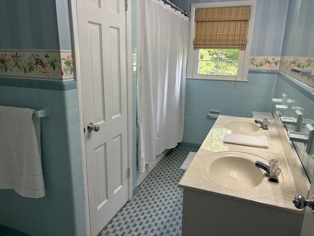 bathroom with vanity and tile walls