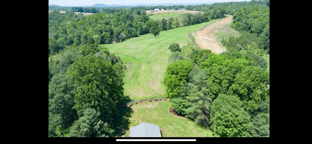 birds eye view of property with a view of trees