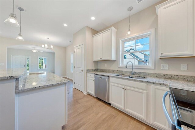 kitchen with light hardwood / wood-style flooring, sink, hanging light fixtures, appliances with stainless steel finishes, and white cabinets