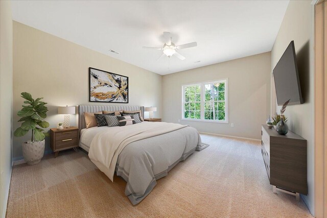 bedroom with light colored carpet and ceiling fan