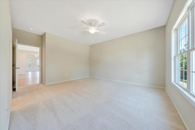 unfurnished room with light carpet and ceiling fan