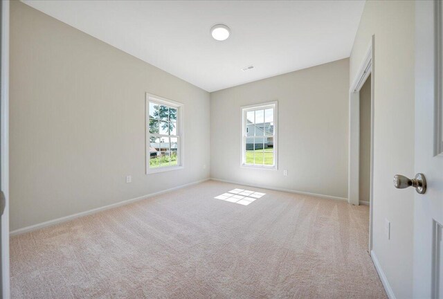 unfurnished room with light colored carpet