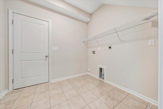 washroom featuring hookup for a washing machine, light tile patterned floors, and hookup for an electric dryer