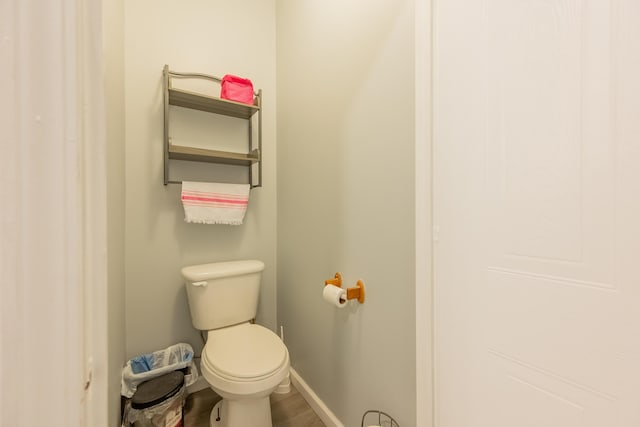 bathroom with hardwood / wood-style flooring and toilet