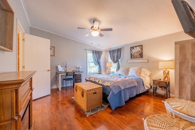 bedroom featuring dark hardwood / wood-style flooring, a textured ceiling, ornamental molding, and ceiling fan