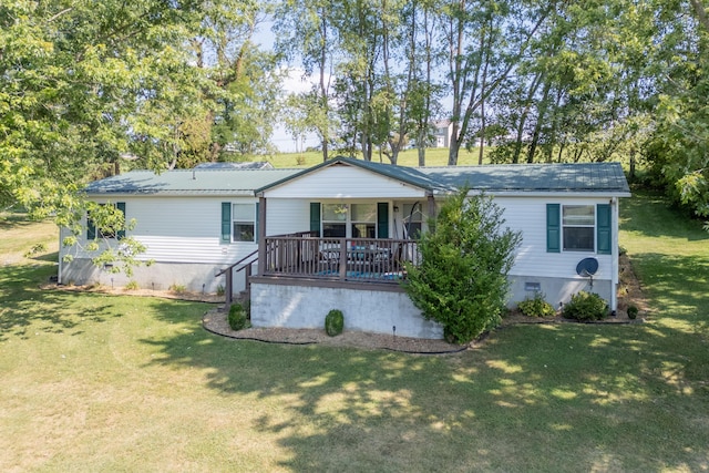 rear view of property featuring a porch and a yard