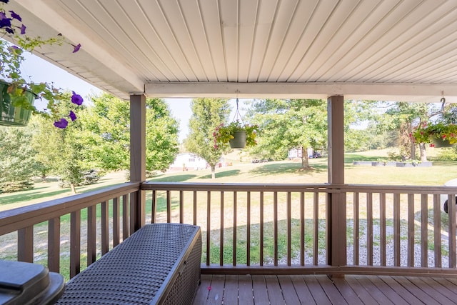 wooden deck featuring a yard