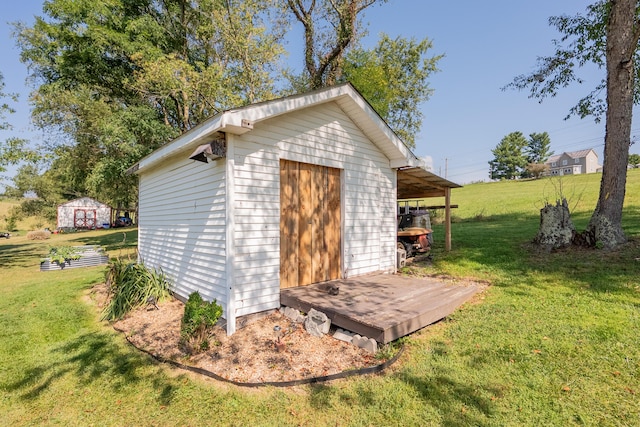 view of outdoor structure featuring a lawn