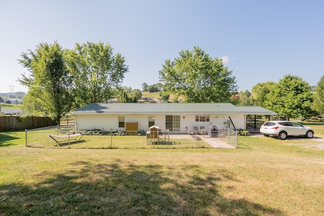 view of front of house featuring a carport and a front lawn